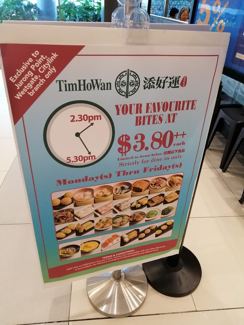 A promotional sign for Tim Ho Wan's afternoon tea special, featuring various dim sum and bites.