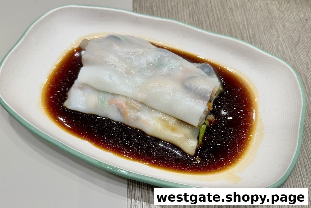 A close-up of delicious rice noodle rolls (Cheung Fun) served with savory soy sauce.