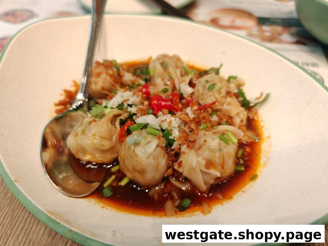 A close-up of savory dumplings or wontons in a rich sauce, garnished with chili, garlic, and spring onions.