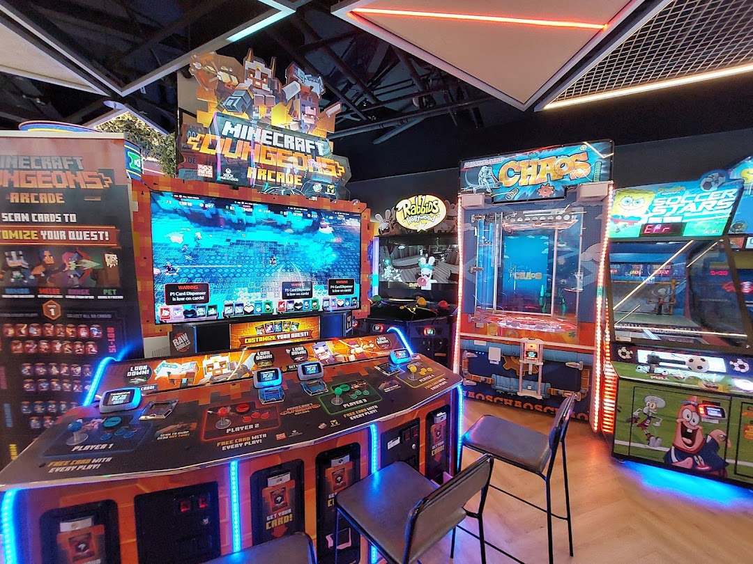 Vibrant arcade interior featuring popular games like Minecraft Dungeons and a claw machine.