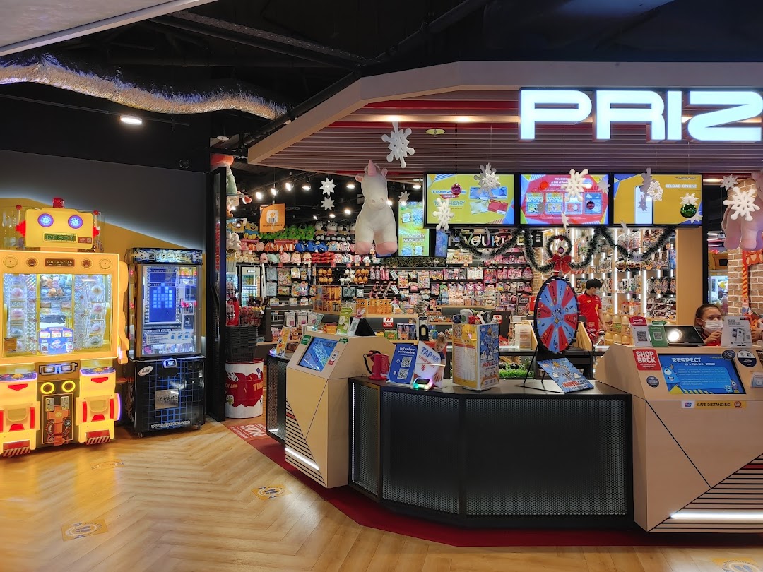 A vibrant prize counter and arcade games at Timezone, filled with merchandise and fun.