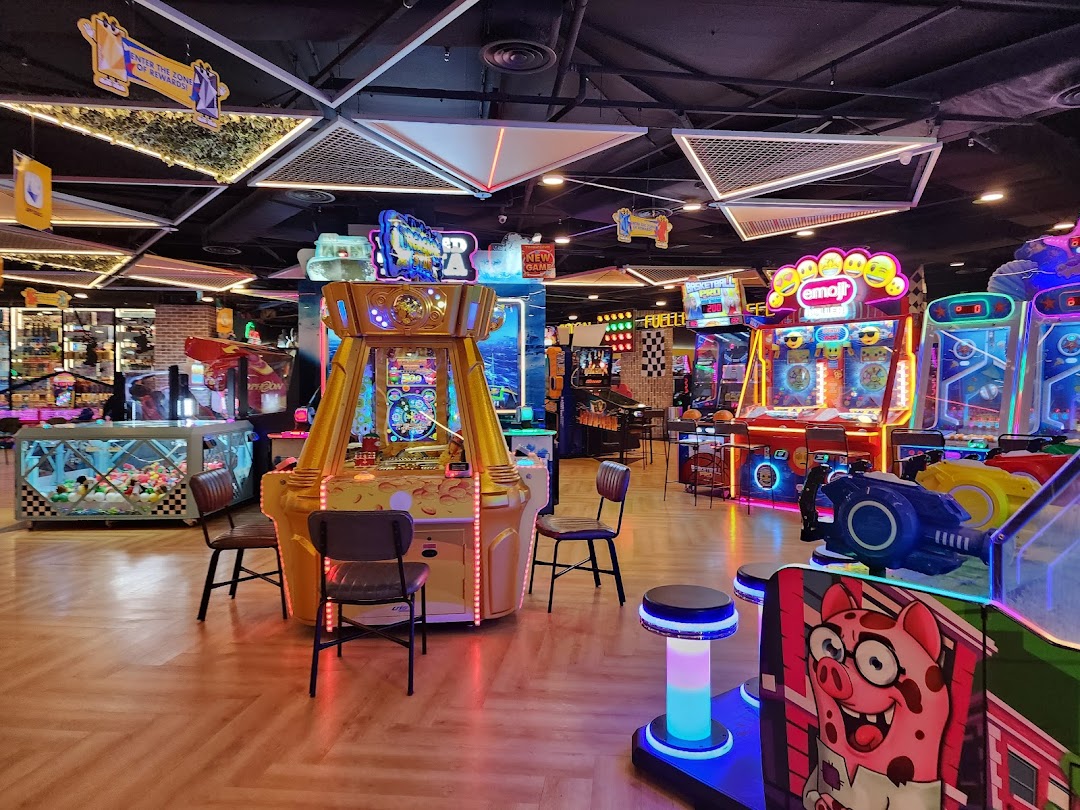 A vibrant arcade interior filled with various colorful game machines and entertainment options.