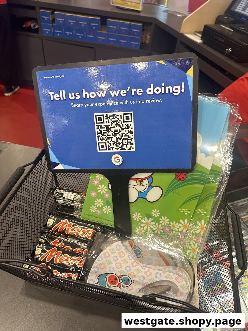 A counter display with a customer feedback sign, QR code, and merchandise like Mars bars and masks.