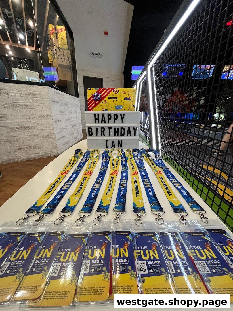 A table set up for a birthday party at Timezone, featuring lanyards and promotional materials.