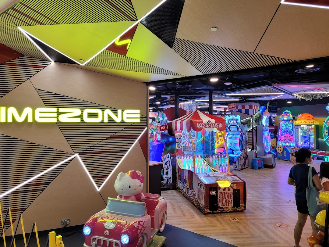 An interior view of Timezone arcade, featuring various colorful games and a Hello Kitty ride.