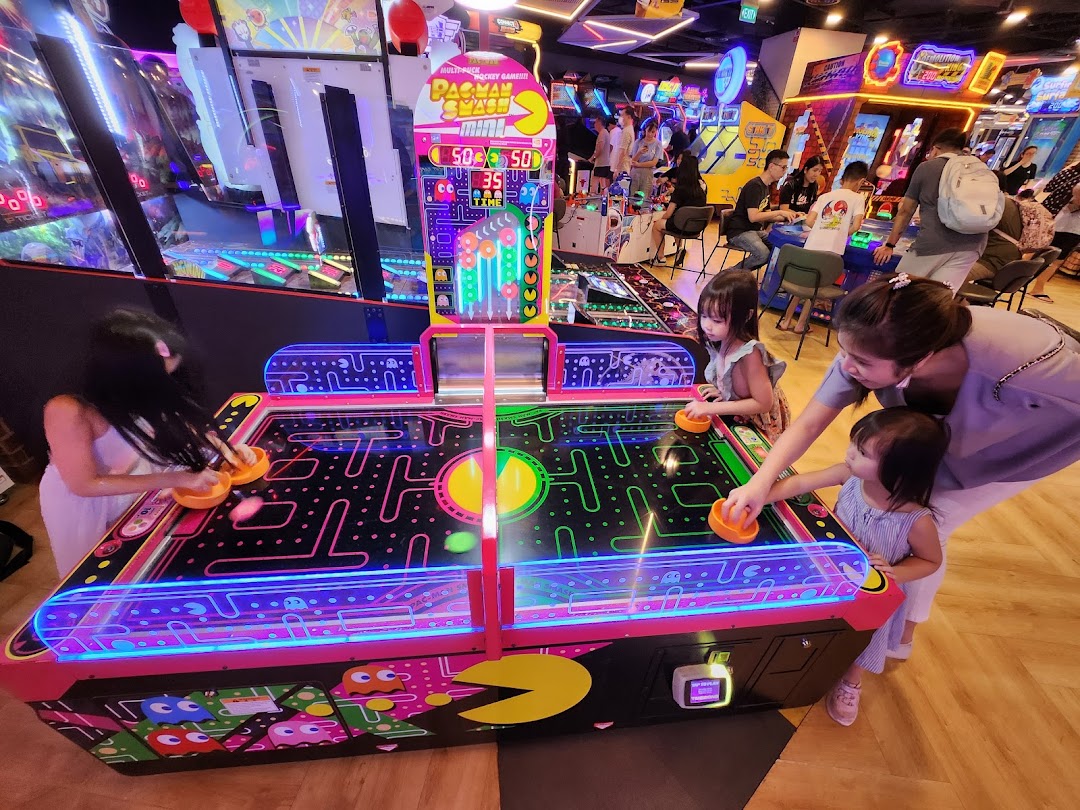 Families and friends enjoy a lively arcade with a Pac-Man air hockey game at Timezone.