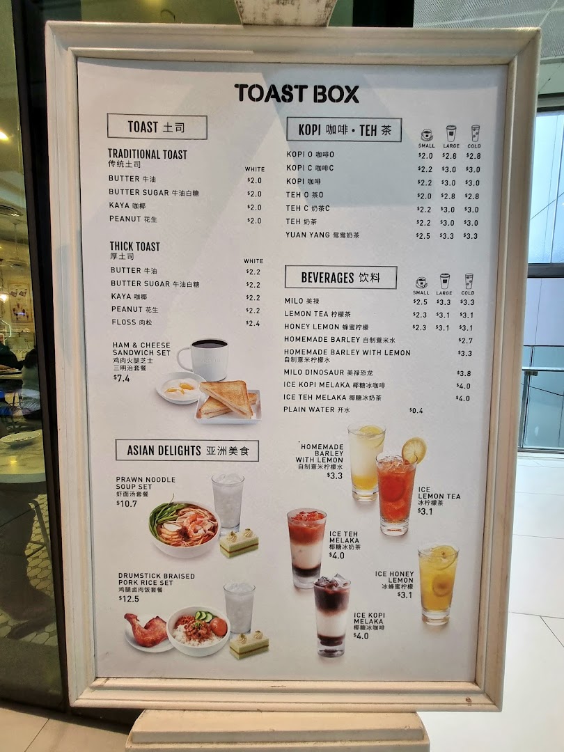 A detailed menu board from Toast Box, showcasing their toast, coffee, tea, beverages, and Asian delights.