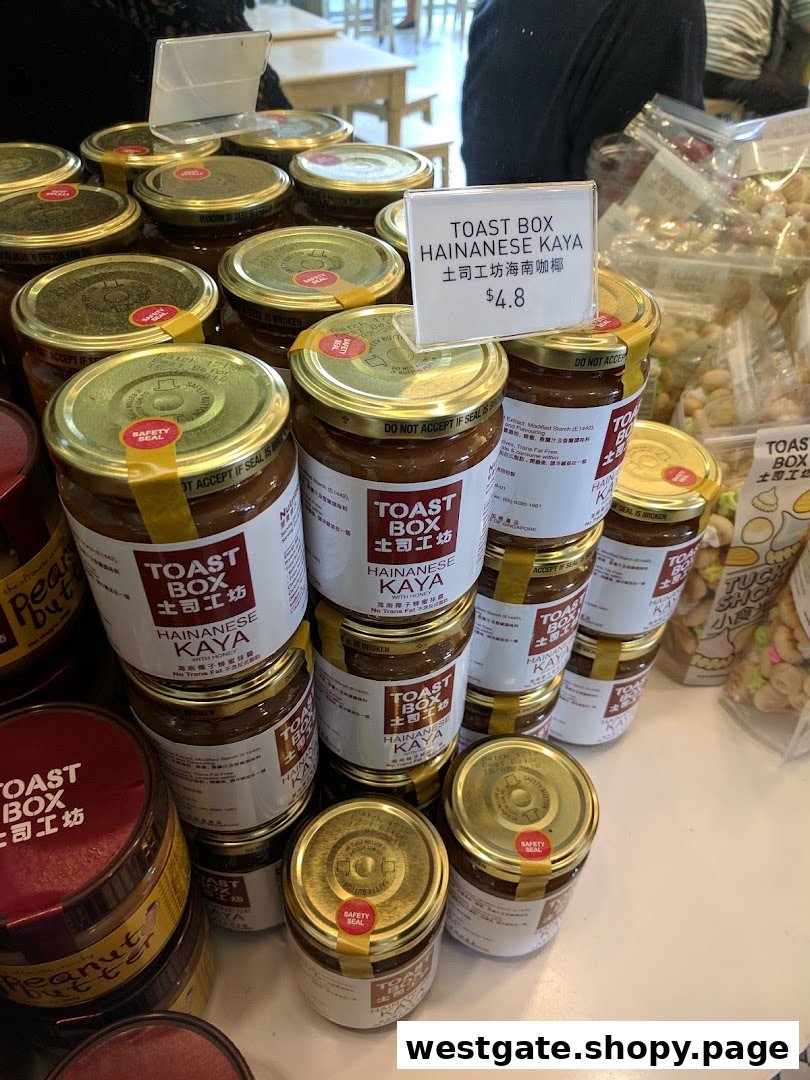 A retail display of Toast Box Hainanese Kaya and peanut butter jars for sale.