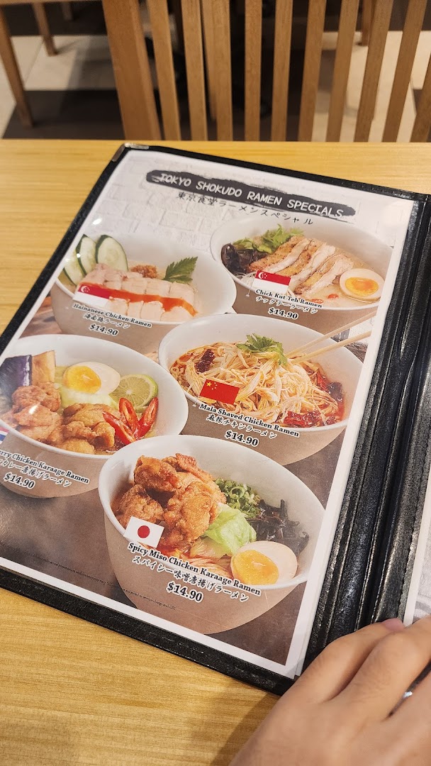 A close-up view of Tokyo Shokudo's ramen specials menu featuring various chicken ramen dishes.