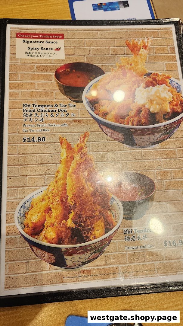 A close-up of a Japanese restaurant menu featuring Ebi Tempura and Tendon dishes with prices.