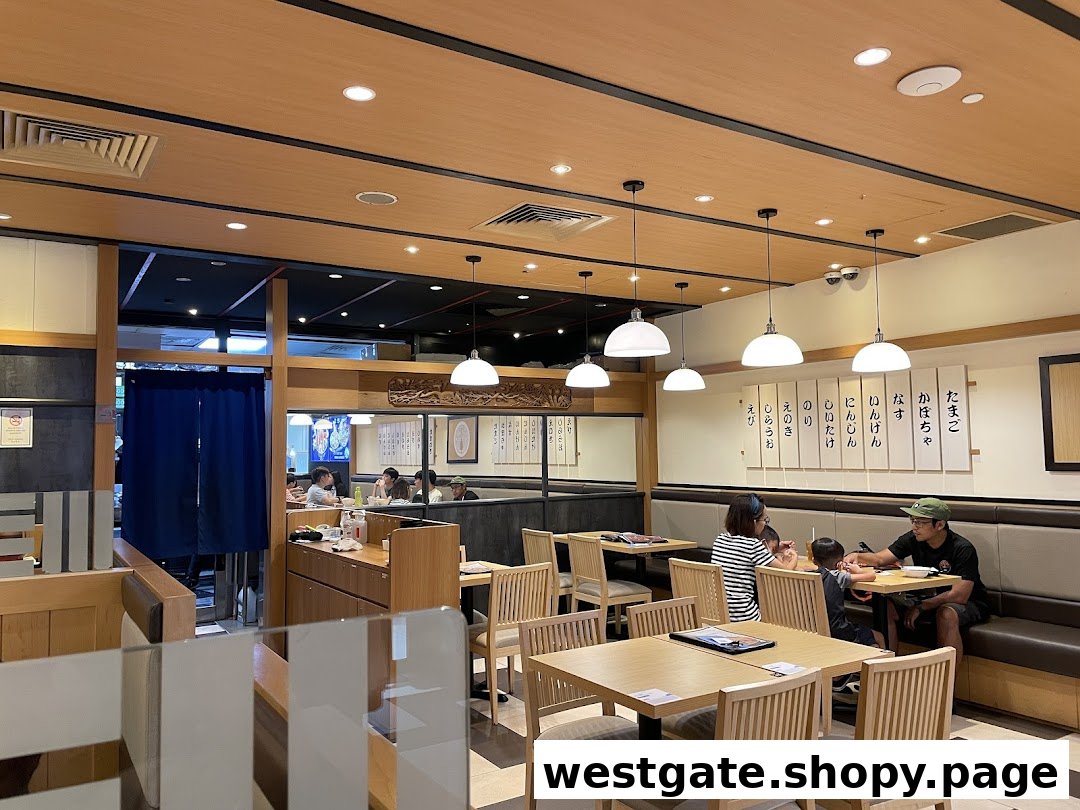 An inviting interior view of Tokyo Shokudo Westgate, featuring wooden decor and comfortable seating with diners.