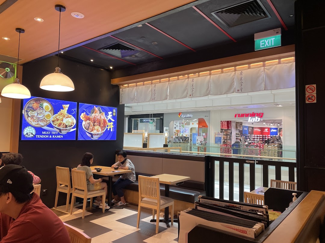 Interior view of Tokyo Shokudo Westgate, showing diners and digital displays featuring Tendon and Ramen.