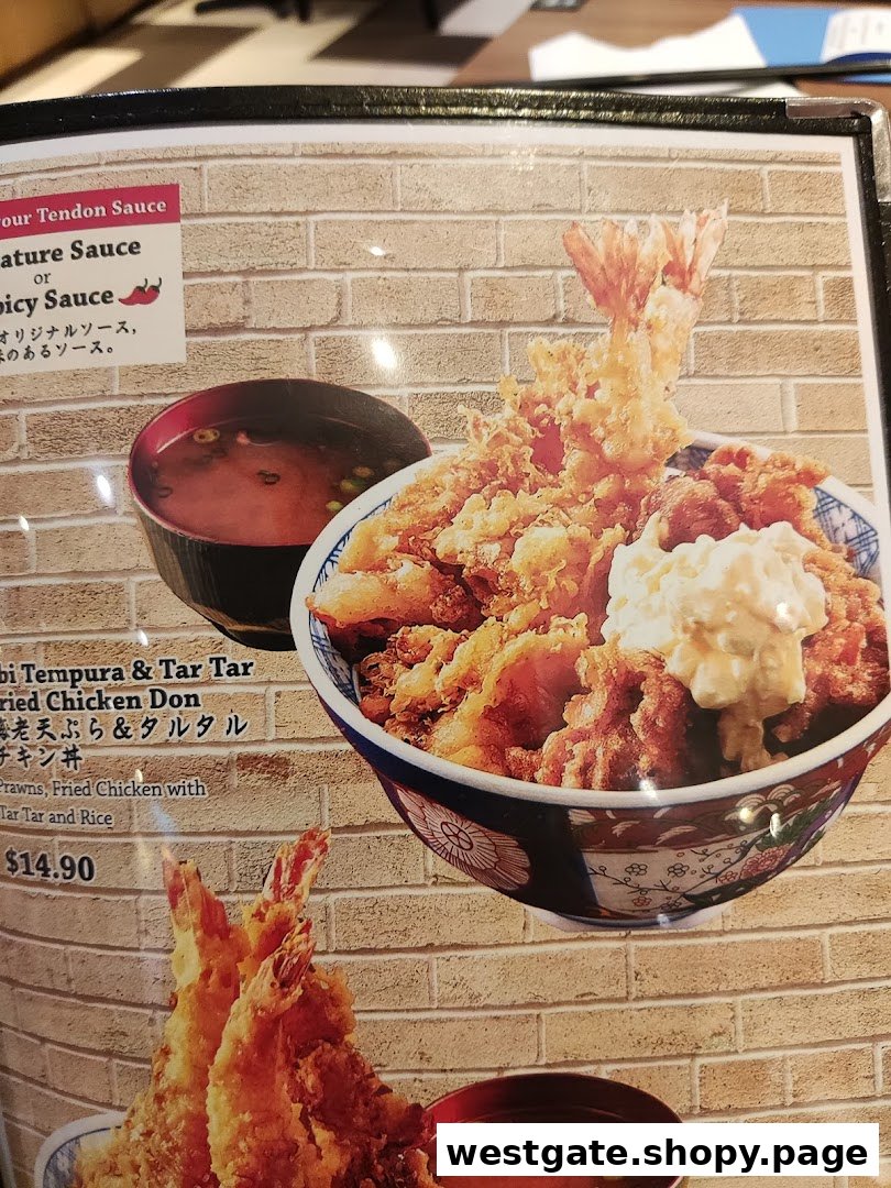 A close-up of a menu page featuring a large image of Ebi Tempura & Tar Tar Fried Chicken Don with pricing.
