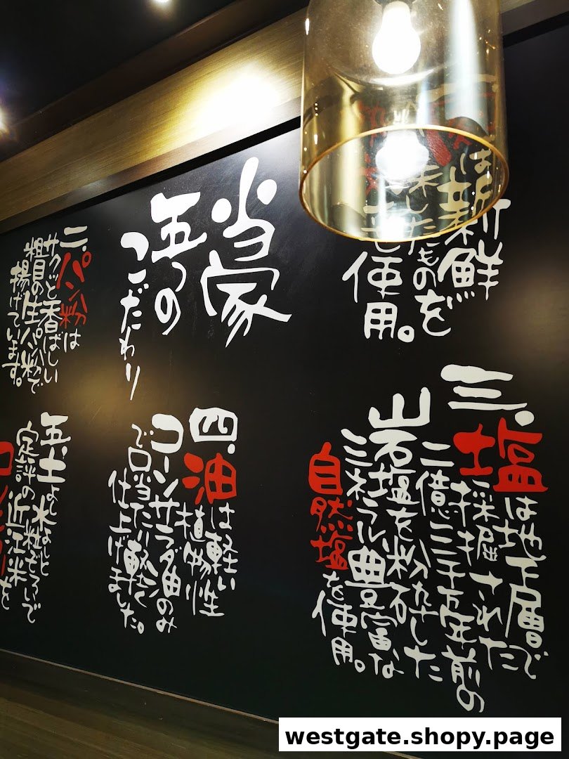 A stylish interior wall with Japanese calligraphy detailing ingredient quality and cooking philosophy.