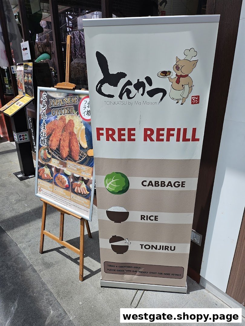 Promotional signs for Tonkatsu by Ma Maison, featuring free refills and Japanese oyster specials at the shop entrance.