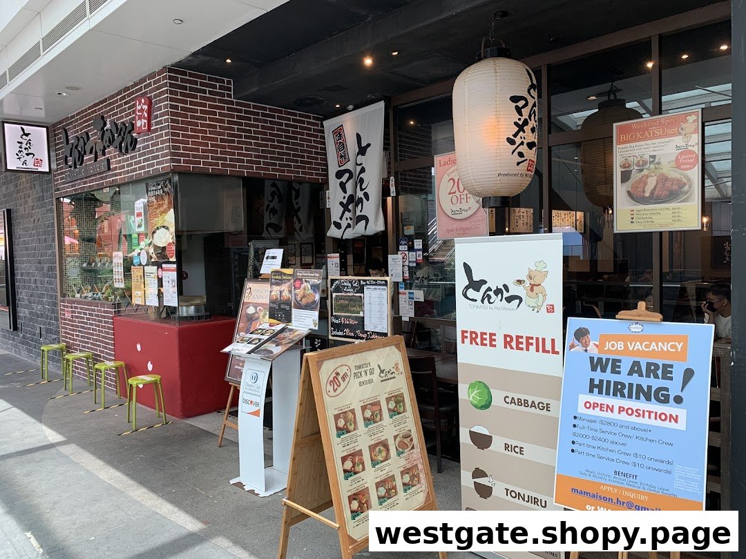 The inviting storefront of Tonkatsu by Ma Maison, featuring promotional signs and Japanese lanterns.