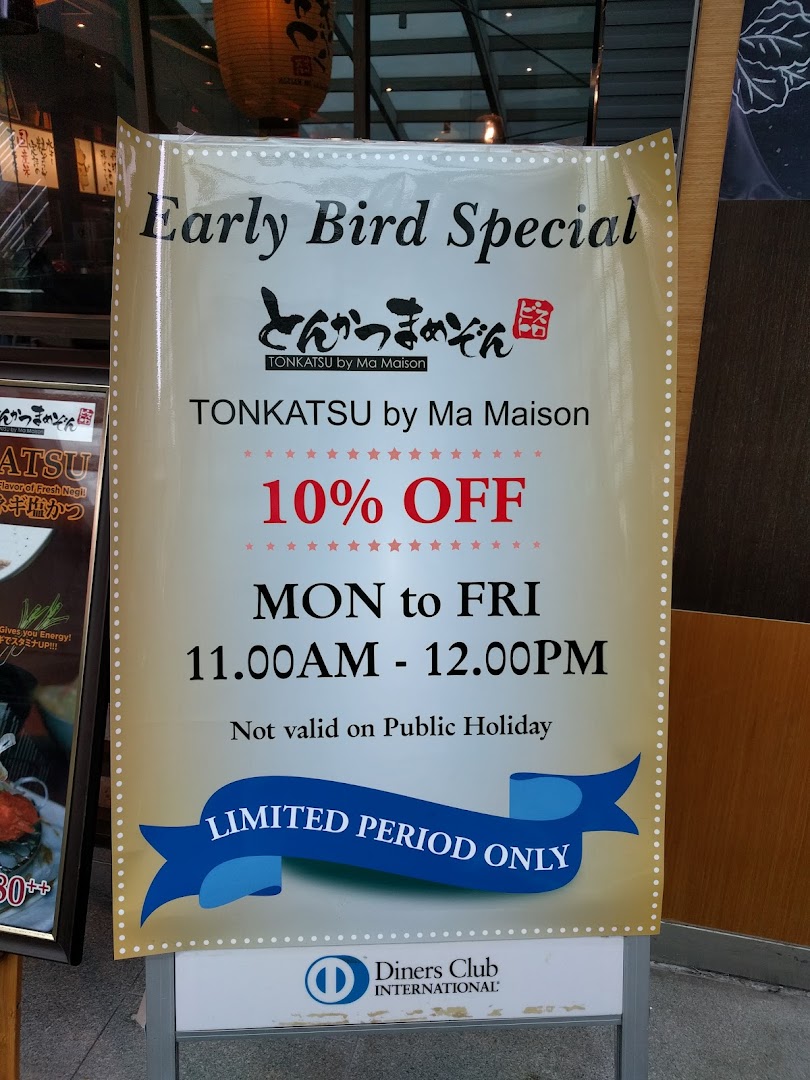 A promotional standee for Tonkatsu by Ma Maison advertising an Early Bird Special with 10% off.
