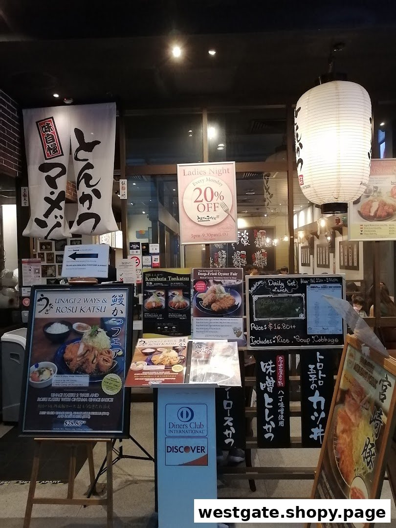 The shopfront of Tonkatsu by Ma Maison, featuring promotional signs and a traditional Japanese lantern.