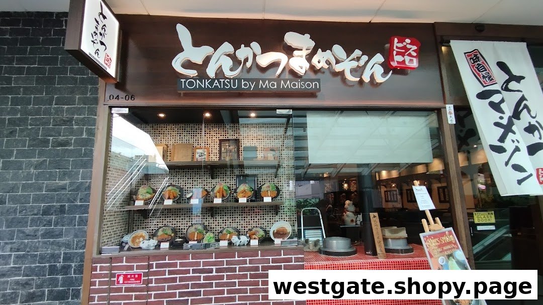 The shopfront of Tonkatsu by Ma Maison, featuring its prominent signage and a display of realistic food models.