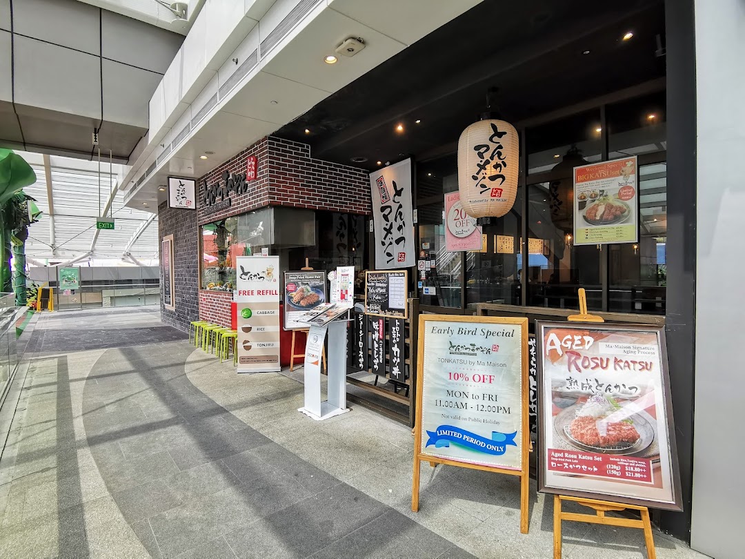The exterior of Tonkatsu by Ma Maison, featuring promotional signs and a traditional Japanese lantern.