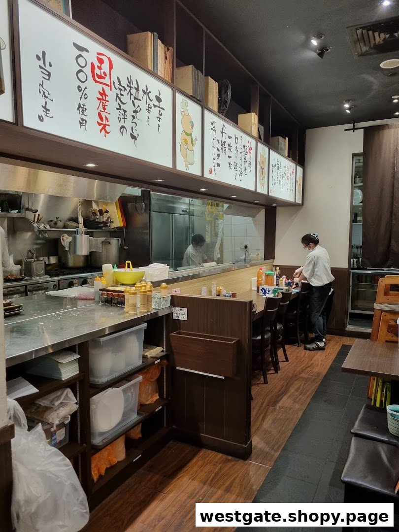 An interior view of Tonkatsu by Ma Maison, showing the open kitchen counter and dining area.