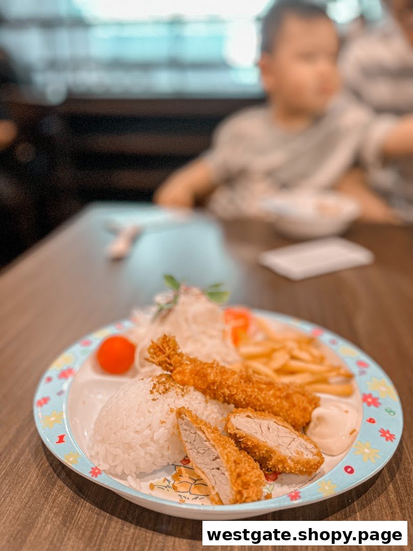 A colorful children's plate featuring tonkatsu, fried shrimp, rice, fries, and salad.