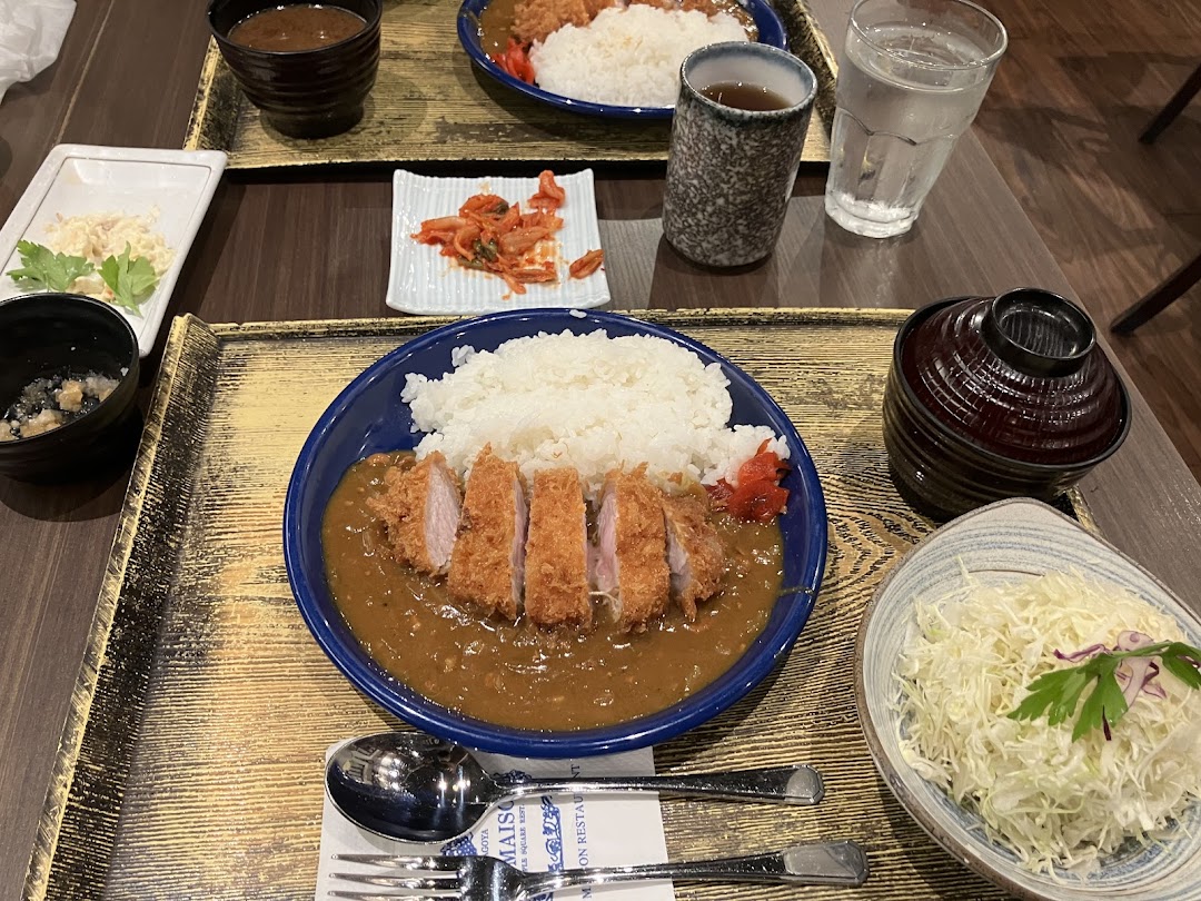 Two delicious Tonkatsu curry rice sets with various sides, showcasing a satisfying Japanese meal.