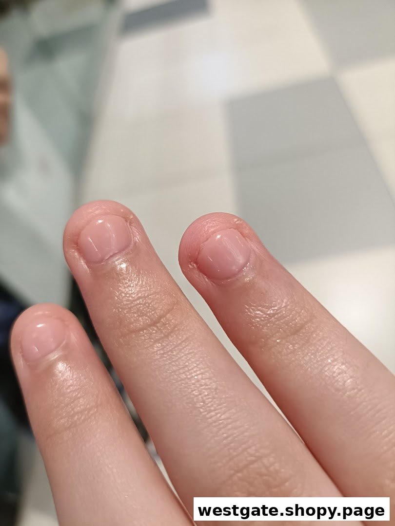 Close-up of fingers showcasing freshly manicured nails with a natural, glossy finish.