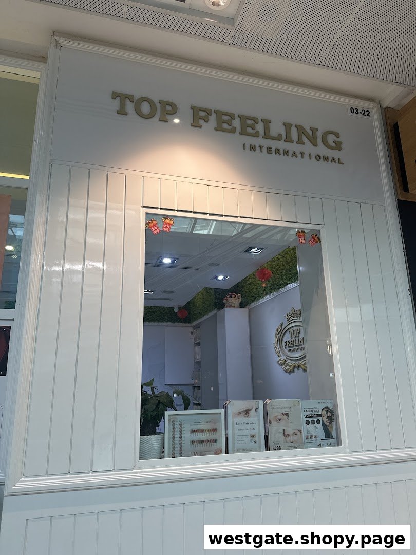 The white facade of Top Feeling International, a beauty salon, featuring its entrance and display window.