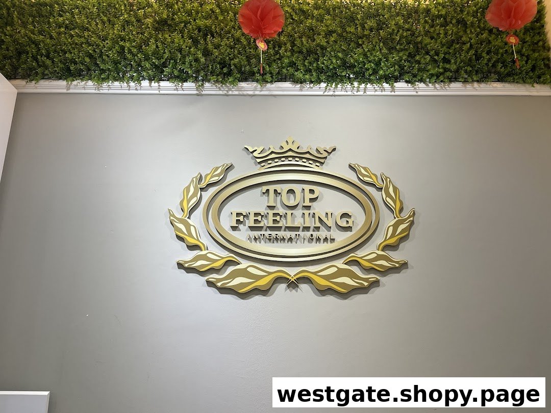 A golden 3D logo for 'Top Feeling International' mounted on a grey wall with green foliage decor.
