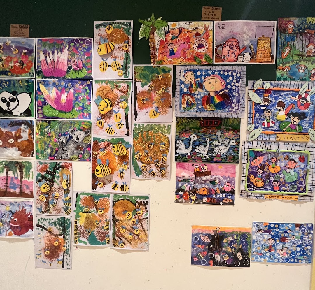 A wall covered with vibrant, diverse artworks created by young students, showcasing their artistic talent.