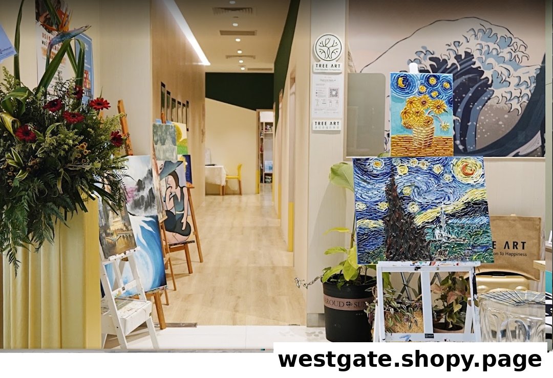 A vibrant art studio hallway featuring easels with paintings, lush plants, and a welcoming creative atmosphere.
