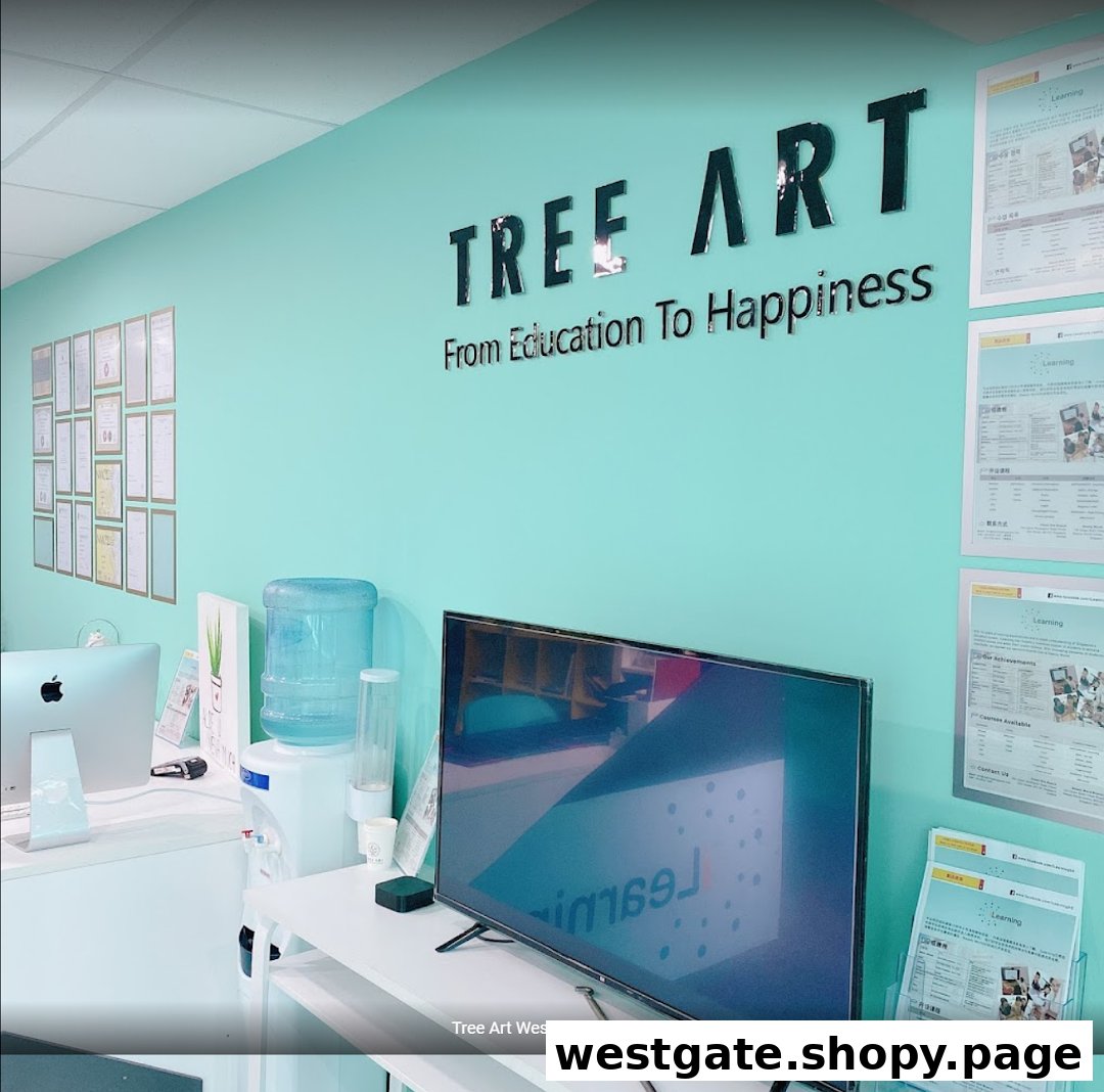 A bright, modern interior of Tree Art learning center with a prominent logo, computers, and display screens.