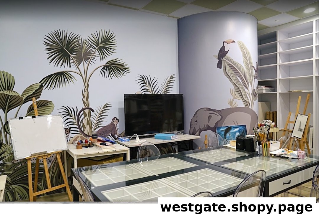 An art studio interior featuring vibrant jungle-themed murals, easels, and a large table with art supplies.