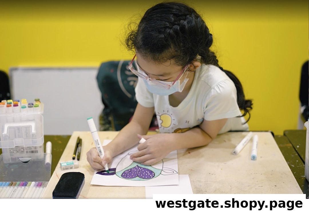 A young student wearing a mask and glasses focuses on coloring an artwork with markers at a desk.