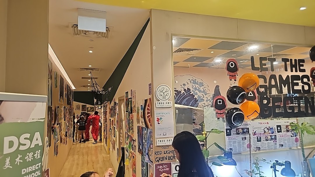 A vibrant hallway adorned with children's artwork leading to a classroom with 'Squid Game' themed decorations at Tree Art.
