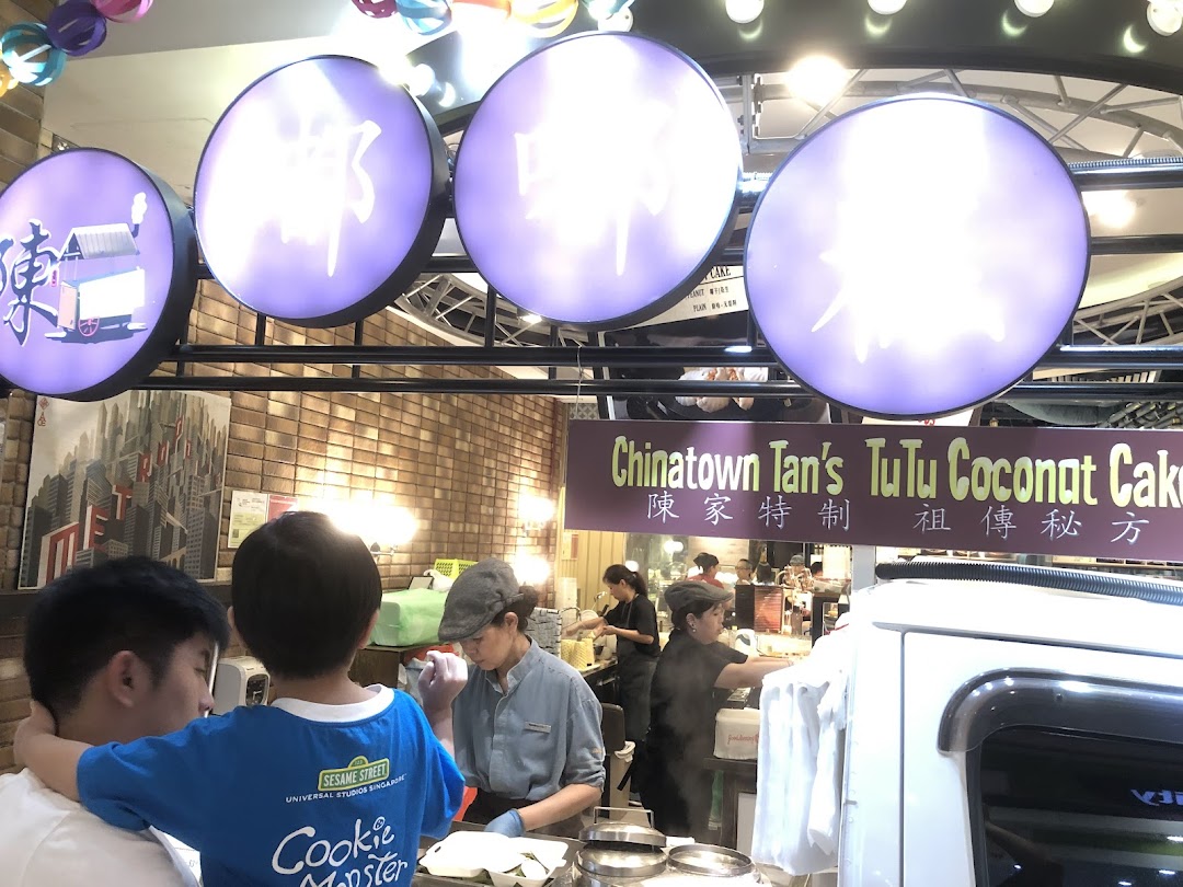 Customers and staff at Chinatown Tan's TuTu Coconut Cake stall, preparing traditional coconut cakes.