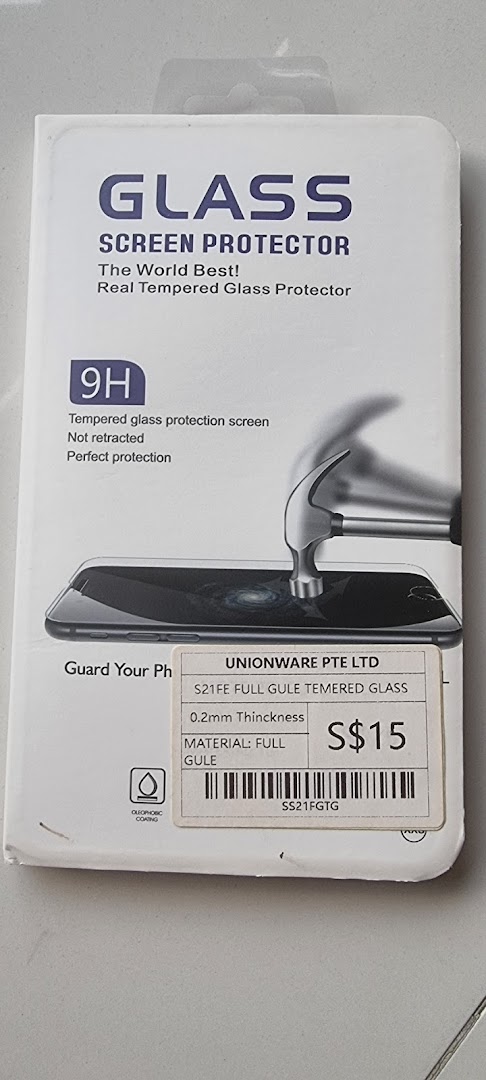 A packaged tempered glass screen protector for phones, featuring 9H hardness and oleophobic coating.