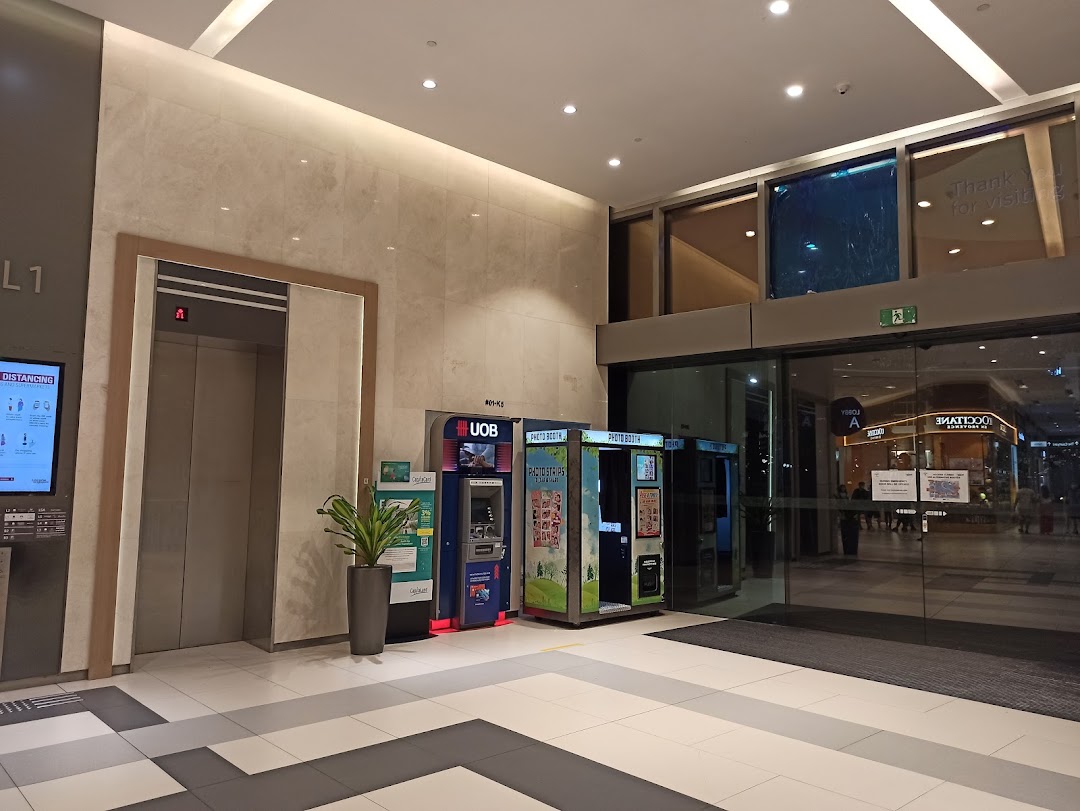 UOB ATM, photobooths, and elevator located near a mall entrance at Westgate.