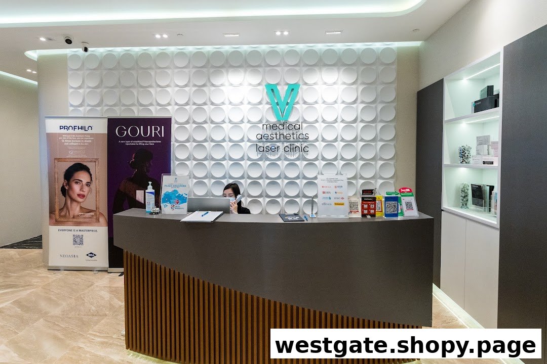 A modern medical aesthetics clinic reception area with a staff member, branding, and promotional displays.