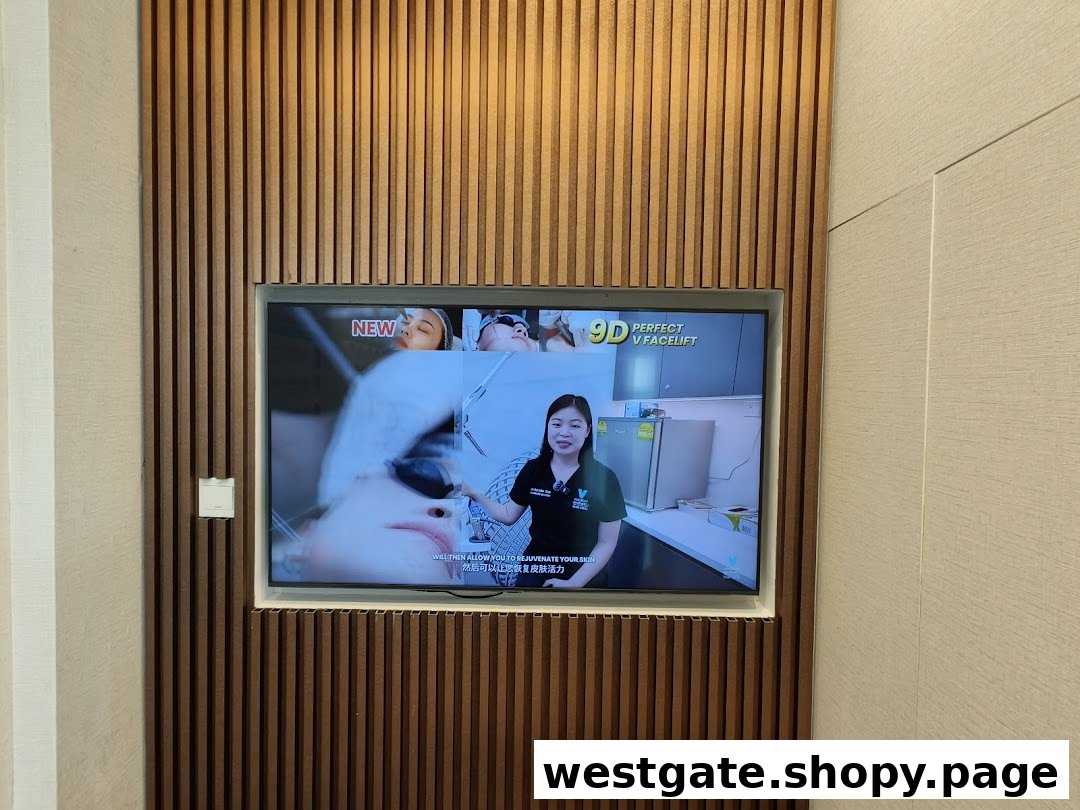 A TV screen mounted on a wooden wall displaying a promotional video for aesthetic treatments.