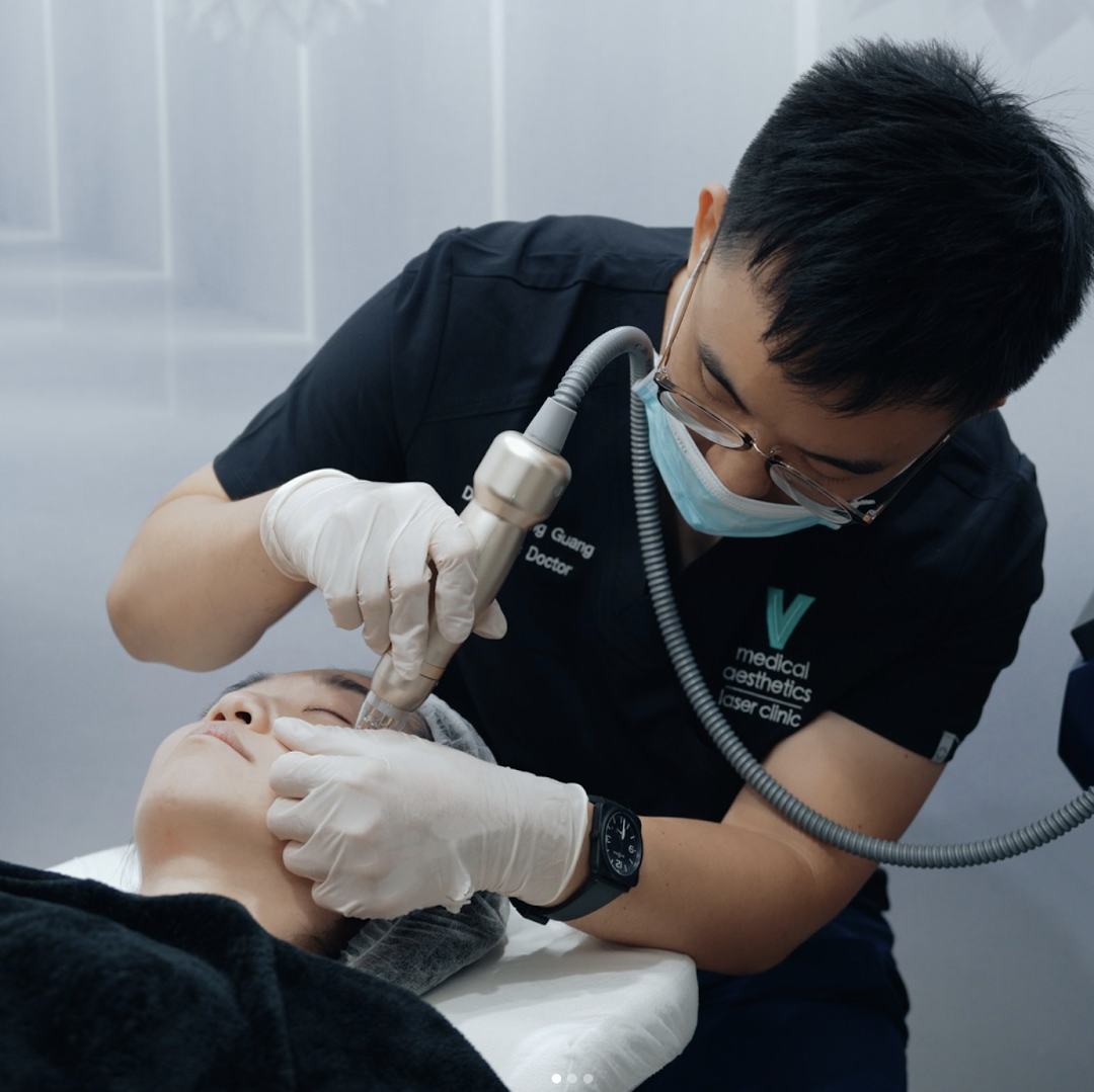 A doctor performs a laser treatment on a patient's face at V Medical Aesthetics & Laser Clinic.