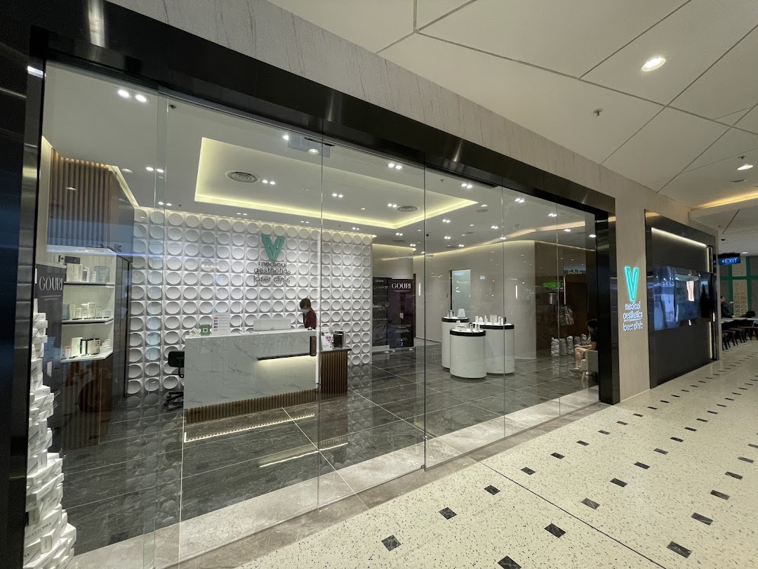 The modern glass shopfront of V Medical Aesthetics & Laser Clinic, revealing its reception area and interior.