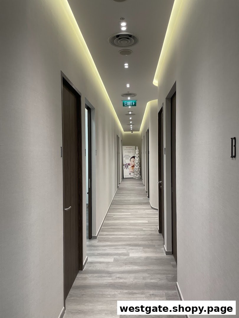 A long, well-lit hallway with multiple doors leading to treatment rooms inside a clinic.