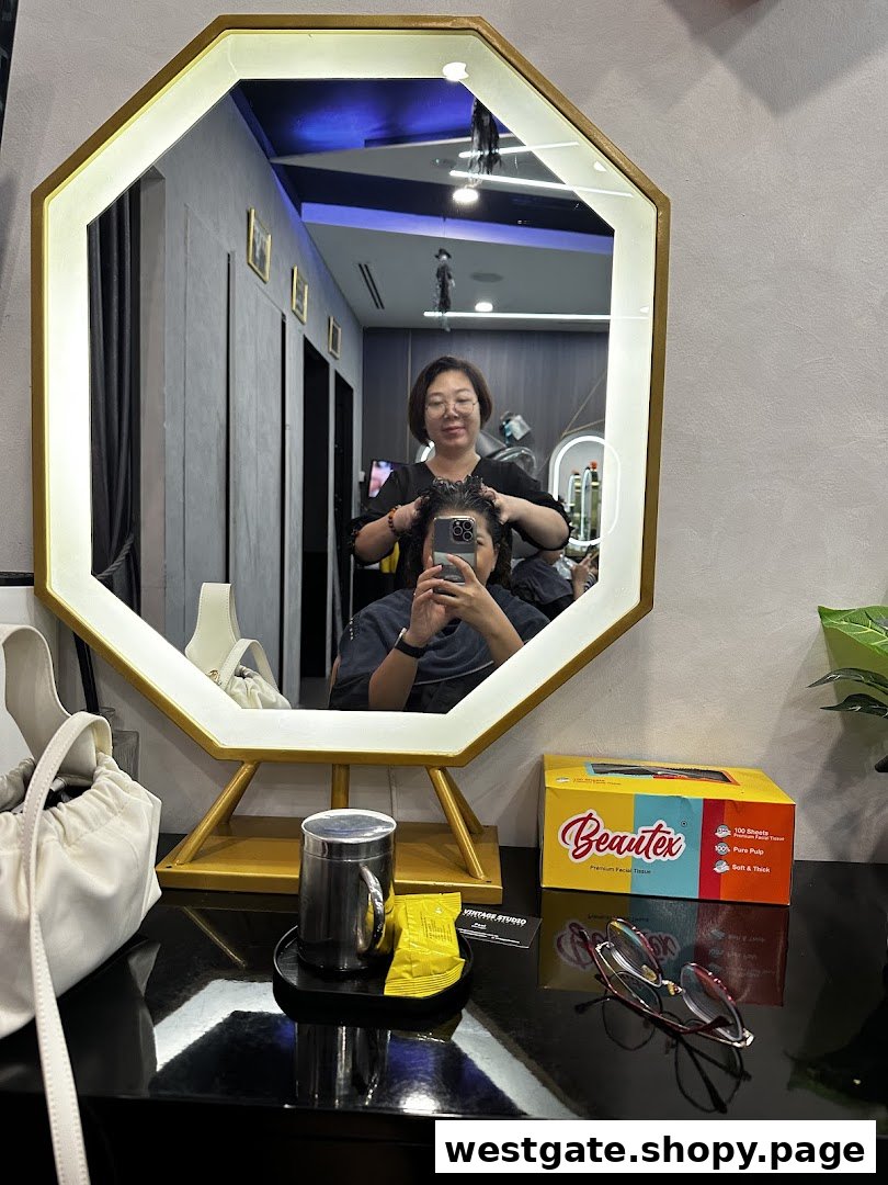 A stylist works on a client's hair, reflected in a modern salon mirror at Vintage Studio.
