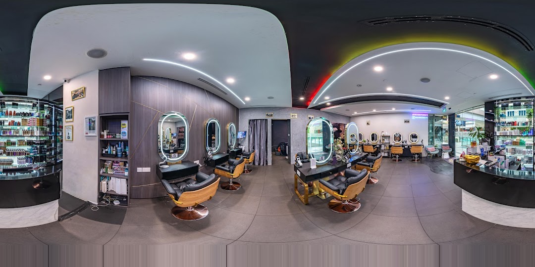 A panoramic view of a modern hair and beauty salon interior with multiple styling stations and product displays.