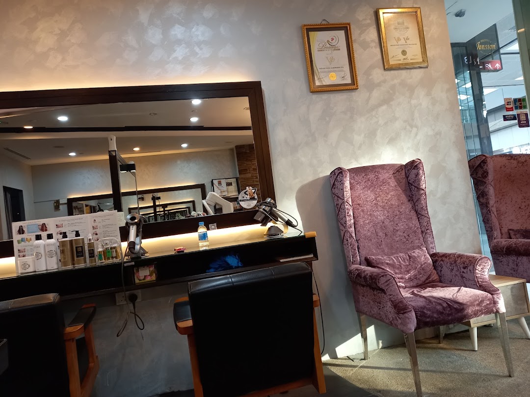 Interior view of Vintage Studio VS Salon, showing styling stations, products, and plush waiting chairs.