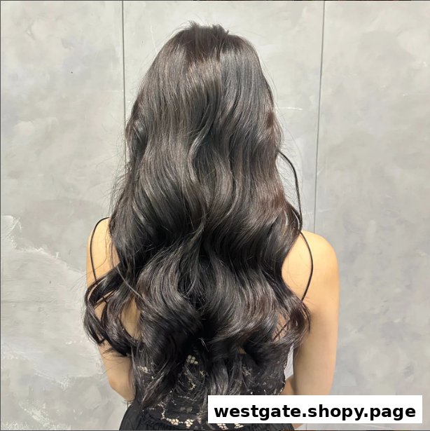 A person's back showcasing long, dark, voluminous wavy hair, likely a salon styling result.