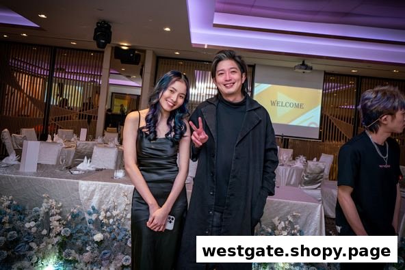 Two stylish individuals, likely salon staff, pose in an elegant event space with a 'WELCOME' screen.