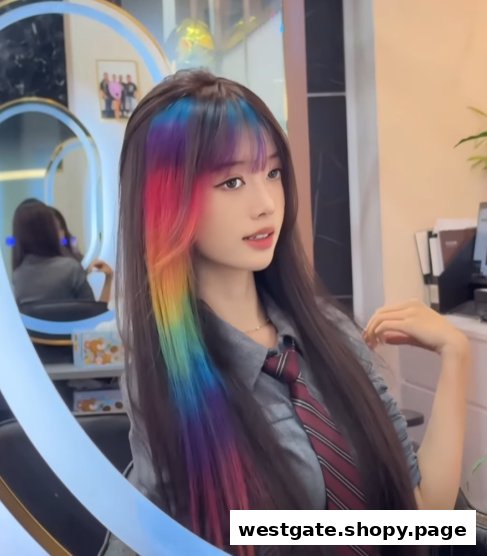 A young woman showcasing vibrant rainbow-colored hair highlights in a salon setting.